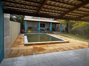 a swimming pool in the middle of a patio at Casa de Veraneio in Caucaia