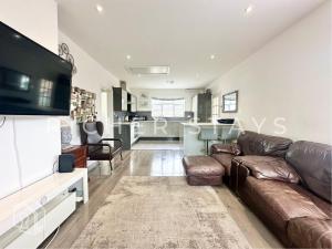 a living room with a couch and a tv at Modern Classic 3-Bedroom Flat in The Hyde