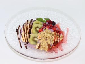 a plate of food with fruit and nuts on it at HOTEL felice Osaka Itami Airport - Vacation STAY 53144v in Toyonaka