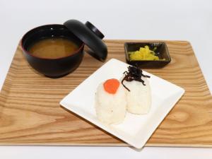 a plate of sushi and a cup of soup at HOTEL felice Osaka Itami Airport - Vacation STAY 53144v in Toyonaka