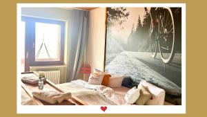 a bedroom with a bed with a picture of a bicycle at Berghupferl-Alm mit Wellnessoase im Garten in Flintsbach am Inn