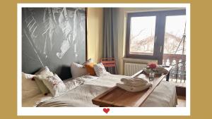 a bedroom with a bed with a table on it at Berghupferl-Alm mit Wellnessoase im Garten in Flintsbach am Inn
