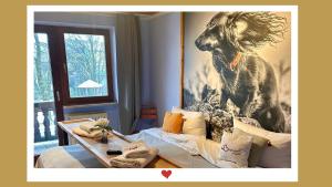 a room with a picture of a dog on the wall at Berghupferl-Alm mit Wellnessoase im Garten in Flintsbach am Inn +36 photos