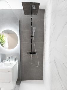 ein Badezimmer mit Dusche und Waschbecken in der Unterkunft Sweet-Thermal Amnéville loisir, parking gratuit in Amnéville + 1 Foto