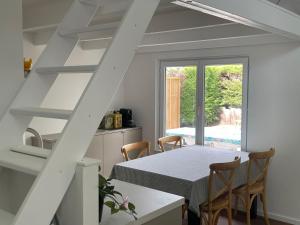 a kitchen and dining room with a table and chairs at Chocolat & Vanille in Koksijde +10 photos