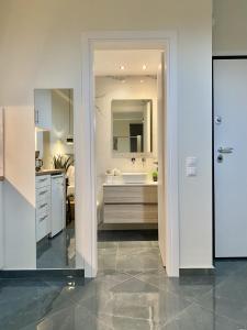 a white bathroom with a sink and a mirror at ATHENIAN Vibes in Athens +42 photos