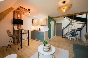 a kitchen and living room with a staircase in a house at L'Exotique Baignoire Double Cozy Duplex in Haguenau