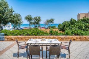 a table and chairs with a view of the ocean at Aegean Horizon in Karfas