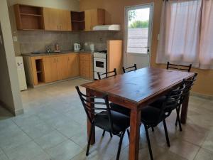 a kitchen with a wooden table and chairs at Las Lilas in Roque Pérez