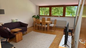 a living room with a couch and a table at Das Steirer-Nest in Sankt Lambrecht