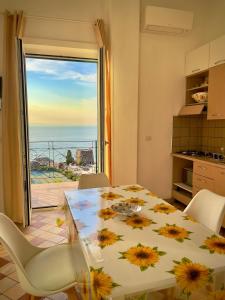 a dining room with a table and a view of the ocean at Seventy Steps in Vico Equense +33 photos