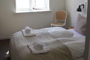 a bedroom with white towels on a bed at Hotel Saxkjøbing in Sakskøbing