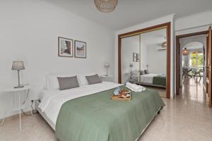 a bedroom with a large bed with a tray on it at Elegant Flat with Pool & Balcony by HostWise in Tavira +16 photos