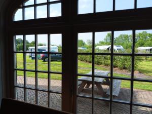a window view of a picnic table and a parking lot at Camping de Haarakker in Langeveen
