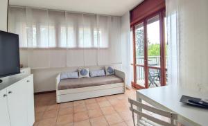 a living room with a couch and a table at Last Minute Booking in Peschiera del Garda