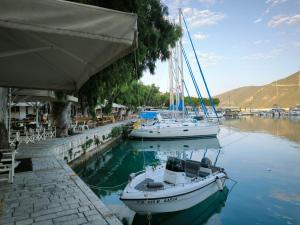 two boats are docked in the water at a marina at Deppy's House in Vasiliki