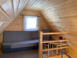 a bed in a tiny house with a window at Ranczo in Rewal +7 photos