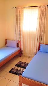 Postel nebo postele na pokoji v ubytování Fully Furnished 3-Bedroom Holiday Villa at Bandari Villas