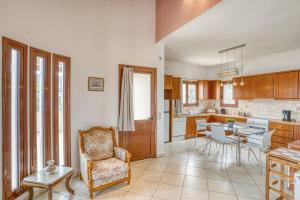 a kitchen with a table and a chair in a room at Sea View Home in Karfas +14 photos