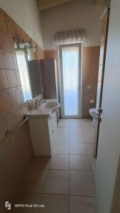 a bathroom with two sinks and a mirror at La casa di Erica in Sestu