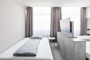 Postel nebo postele na pokoji v ubytování Rimedya Hotel - an der Messe München