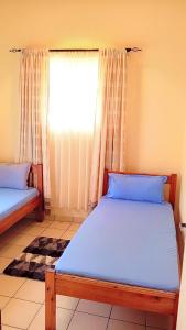 Postel nebo postele na pokoji v ubytování Fully Furnished 3-Bedroom Holiday Villa at Bandari Villas + 24 fotografií