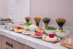 a buffet with bowls of food on a counter at Nars Plus Al Naeem Hotel in Jeddah