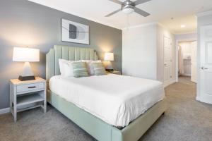 a bedroom with a bed and a nightstand with two lamps at Landing Bellingham Park - Wilmington in Wilmington