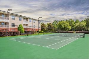 a tennis court in front of a building at Landing Bellingham Park - Wilmington in Wilmington