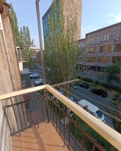 a tree branch on the balcony of a building at Sweet Home Mergelyan in Yerevan