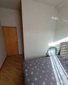 a bedroom with a bed and a wooden door at Sweet Home Mergelyan in Yerevan +2 photos