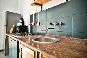 a kitchen with a sink and a stove at Marzasee - loft in Marzamemi +18 photos
