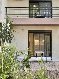 a house with a table and chairs on the balcony at ATHENIAN Vibes in Athens +45 photos