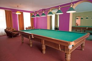a pool table in a room with purple walls at Golubaya Volna in Rostov on Don