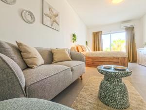 a living room with a couch and a table at Jandia Sunrise, Your Sweet Holiday Home in Morro del Jable