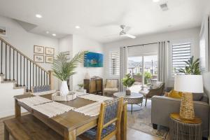 a dining room with a table and a living room at Happy Hawaiian Themed Condo in Washington
