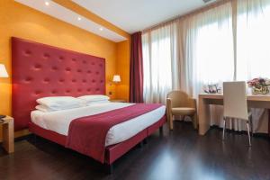 Кровать или кровати в номере Best Western Hotel Piemontese