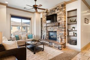 a living room with a stone fireplace with a tv at The View - Resort Amenities & Epic Views in Washington