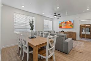 a living room with a table and a couch at Cliffside Vista - Stay for 7 in Hurricane +35 photos