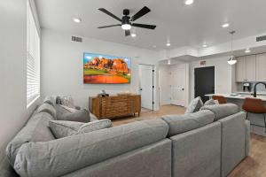 a living room with a couch and a ceiling fan at Cliffside Vista - Stay for 7 in Hurricane