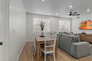 a living room with a table and a couch at Cliffside Vista - Stay for 7 in Hurricane