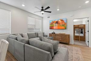a living room with a couch and a ceiling fan at Cliffside Vista - Stay for 7 in Hurricane