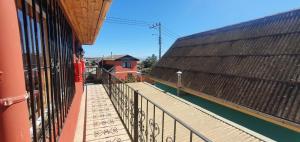a balcony of a building with graffiti on it at Cabañas Jardín Alto in Pichilemu