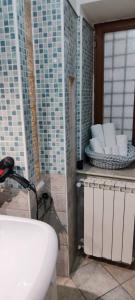 a bathroom with a sink and some tiles on the wall at Nino in Foligno +19 photos