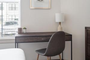a desk with a chair and a lamp on it at Landing Apartments Austin - Pflugerville in Pflugerville +33 photos