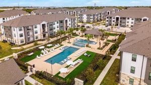 an aerial view of an apartment complex with a swimming pool at Landing Apartments Austin - Pflugerville in Pflugerville