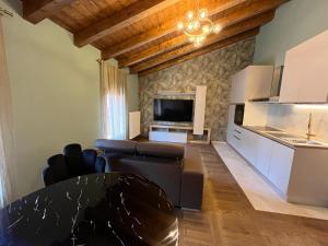 a living room with a couch and a table at Suite Deluxe Appartaments Gold in Fabbrico