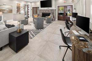 a living room with a couch and a fireplace at Landing Apartments - Summerville in Summerville