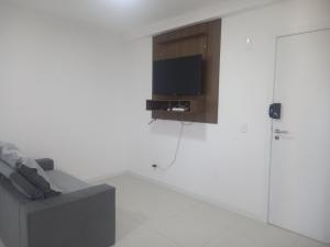 a white room with a tv on a wall at Horizonte Infinito - Skyline Comfort Club - Penha in Penha