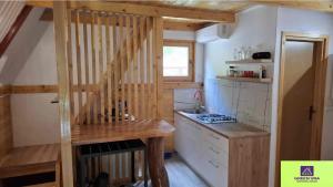 a small kitchen with a wooden staircase in a house at Green Una Wooden House in Kulen Vakuf
